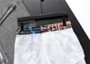 2024夏のデザイナーメンズショーツレジャースポーツバケーションサーフィンパンツファッションクイック乾燥メンズビーチパンツブラックアンドホワイトレタープリントユニセックス衣類M-3XL