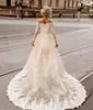 2024 En linje korta bröllopsklänningar vintage av axel långa ärmar spetsar applikationer avtagbara tåg överskjolar två stycken hi lo längd svep tåg sexiga brudklänningar