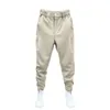 Pantalones para hombres Hombres Casual Elástico Cintura Botón Bolsillos largos Color Sólido Sujeción Cinta Puños Tenis Pantalones deportivos