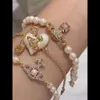 Designer Viviane Westwoods Viviennr High Version Empress Dowager Vivienne Olympia Cross Line Pearl Armband med lyxig och lyxig känsla