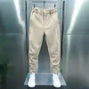 Pantalones para hombres Hombres Casual Elástico Cintura Botón Bolsillos largos Color Sólido Sujeción Cinta Puños Tenis Pantalones deportivos