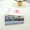 Andra bordsdekorationstillbehör Fashion Fake Books Storage Box Modern Simulation Book Home Decor Luxury Decorative Living Room Paris New York YQ240125