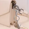 Schlüsselanhänger im industriellen Stil, spezieller tragbarer Feder-Doppelspulen-Schlüsselanhänger, kreativer elastischer Anhänger, Taillenaufhängung, vielseitiger Metallring
