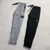 Pantaloni firmati Stone Island Pantaloni da uomo Grapestone di alta qualità Pantaloni sottili primaverili/estivi in rete di nylon metallico Pantaloni sportivi in nylon da strada per uomo e donna