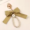 Nyckelringar söt stor båge faux pärla lanyard nyckelkedja för kvinnliga flickväska hörlurar hänga kedjor keyring smycken