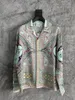 23SS New Casablanca Designer Fashion Classic men and women Shirt Hawaiian Oasis Island Lazy Scenery Satin Kamehameha King Long Sleeved Shirt Tide