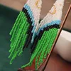 Orecchini pendenti Perline di riso intrecciate a mano con piume di pavone colorate di fascia alta, nappe lunghe, da donna