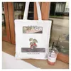 ショッピングバッグハラジュクカジュアルホワイトシンプルなプリント女性ハンドバッグキャンバスバッグ漫画の手紙再利用可能なショルダーバッグ。