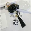 Key Rings Famous Keyring Black White Leather Camellia Flower Keychain Women Flower Key Chains llaveros flore Bag Charms 240303