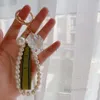 Porte-clés Designer Charme de luxe Bague féminine Perle Charme Ruban vert Coquilles délicates GGG Pendentif Cadeau 240303