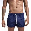 Mäns shorts strandbyxor fick utsmyckning polyester snabb torkning ungdom fast färg casual sport trepunkt