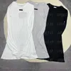 T-shirt da donna a maniche lunghe con lettere M. Top lunghi da donna. Camicie eleganti con scollo tondo grigio
