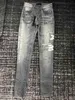 Jeans da uomo 2023 moda Skinny Jeans da uomo pantaloni lunghi Distruggi la trapunta Strappato dritto nero Moto buco designer jean Uomo Abiti firmati 240305