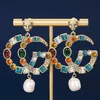 Les boucles d'oreilles en diamant colorées à double lettre en G montrent des boucles d'oreille Baroque rétro exagérées