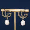 Les boucles d'oreilles en diamant colorées à double lettre en G montrent des boucles d'oreille Baroque rétro exagérées