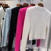 Kvinnors stickor Tees 23 Tidig höst Nya kvinnors kläder Metal Buckle Shoulder Pad Ice Silk Sticked Elastic Short Cardigan Top Jacket