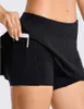 Pantalons actifs Jupes de tennis Pantalon de yoga plissé Vêtements de sport Sous-vêtements pour femmes Jupe de fitness Pantalons de yoga Shorts de sport Short de sport avec poche arrière et fermeture éclair 240308