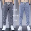 メンズのための春と秋のジーンズ耐性作品ゆるいフード付きハランパンツ汎用カジュアルロング男性