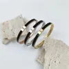 Bracciale rigido intarsiato in porcellana nera in acciaio inossidabile, regalo di gioielli impermeabile e non sbiadito da donna con zirconi alla moda