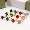 12 Mix Couleurs Unique Diamant Classique Amour Bague Fleur À Quatre Feuilles De Luxe Marque En Acier Inoxydable Couple Anneaux Mode Femmes Designer Bijoux