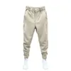 Pantalones para hombres Harem Casual Tenis Estilo deportivo con cintura elástica Botón Fijación Puños de cinta de lujo para otoño / invierno