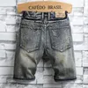 Jeans da uomo Moda Pantaloncini di jeans Pantaloni estivi larghi con fori dritti per uomo Modello mendicante Pantaloni hip-hop con patch rovinati Adolescente