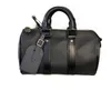 Men's designer cross-body bag in black leather in the shape of a cylinder