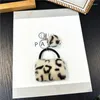 Keychains 100st/mycket Vacker metall leopard tryckväska Keyrings Creative Zinc Alloy for Gift