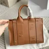 Högkvalitativ designare Väska Kvinnor Handväskor Woody Tote väska shoppingväska axelväska mode linne stora strandpåsar designer resor crossbody plånböcker 240315