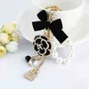 Designer Luxury Dripping Oil Camellia Accessories Utsökta Bow Pearl Chain Bag Keychain Pouch for Girls Llaveros Gift YS072 GGF6