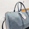 Top 5A Luxurys Bolsas de mezclilla Diseñador Bolsa de viaje Bolsos Bolso de mano Mujer y hombre Nueva textura de moda Multifuncional Portátil Bolsas de compras de gran capacidad