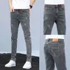 Lente nieuwe jeans Koreaanse veelzijdige trendy elastische slanke pasvorm kleine voeten heren casual lange broek voor heren