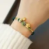 Strang Kupfer Vergoldetes Handseil Pfirsichblüten-Transferperlenarmband Einfacher alter Stil Großes Jahr Fu-Markenschmuck Gewebt Rot