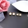 Ohrstecker Kissme Exquisite Muschel Kreuz Blume für Frauen Einzigartige schwarze Emaille Goldfarbe Messing 2024 Modeschmuck