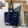 Çok yönlü Koreli Versiyon Instagram Stil Minimalist Casual Tuval Çantası Öğrenci Sınıfları Büyük Kapasite Mektubu Tek Omuz Tuval Çantası 240315