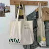 Veelzijdige Koreaanse versie Instagram-stijl Minimalistisch Casual canvas tas Studentenklassen Grote capaciteit Letter Enkele schouder canvas tas 240315