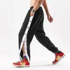 Pantalones para hombres Hombres con cordón Pantalones de cintura elástica Ajuste suelto Deporte con cierre de botón lateral Diseño de pierna ancha para gimnasio