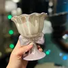 Tasses 2024 Design créatif de haute apparence Pearl Glaze Bow Crème glacée Pieds en céramique Coupe pour boire à la maison