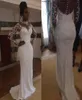Delicati abiti da sposa a sirena in rilievo con applicazioni in pizzo 3D Collo alto sudafricano Illusion Manica lunga Bottoni ricoperti sul retro Bridal5574543