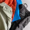 Męskie szorty Wysokiej jakości lato C P swobodne spodenki młodzież stały kolor metalowy odznaka nylonowe spodnie luźne spodnie plażowe pięć ćwiartki J240319