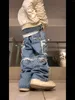 Jeans para hombres Costuras de borlas rasgadas y pantalones de pierna recta sueltos de pierna ancha drapeados de estilo americano de High Street para mujeres Hip Hop