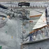 Tendenza streetwear del marchio viola con inchiostro spruzzato e pantaloncini di jeans strappati per uomini nell'estate 481