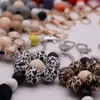 Wholesale of cross-border new beaded pendants, bags, pendants, women's accessories, creative leopard print wood bead tassel keychains