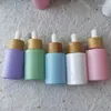 Garrafas de armazenamento 10pcs tampas de bambu rosa verde roxo azul 30ml luxo óleo essencial soro conta-gotas de vidro com pipeta embalagem cosmética