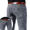 Jeans masculinos cinza denim masculino calças elásticas moda longa fina alta rua pés pequenos calças