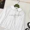 Blouses pour femmes de créateurs Chemises 24SS début du printemps nouveau doux et réduisant l'âge conception de cordon épissage broderie ongles diamant poupée cou chemise courte