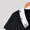 Robes de soirée prix de liquidation femmes fleur broderie noir simple boutonnage mini robe