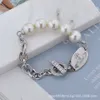 Viviennes Viviane Westwood bijoux Bracelet femmes haute qualité ronde marque perle Ot boucle Saturn Bracelet épissage planète Bracelet haute Version