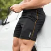 Shorts pour hommes Hommes Side Slit Fitness à séchage rapide avec poches de taille élastiques Streetwear Lettre Imprimer pour actif