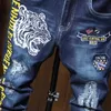 Men's Jeans New Mens Autumn Tiger Head Embroidered Jeans Personalized Blue Elastic Jeans Classic Motorcycle Hip Hop Trousers J240328